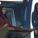 Michael Burnham and Commander Nhan stare intently on the Discovery's bridge.